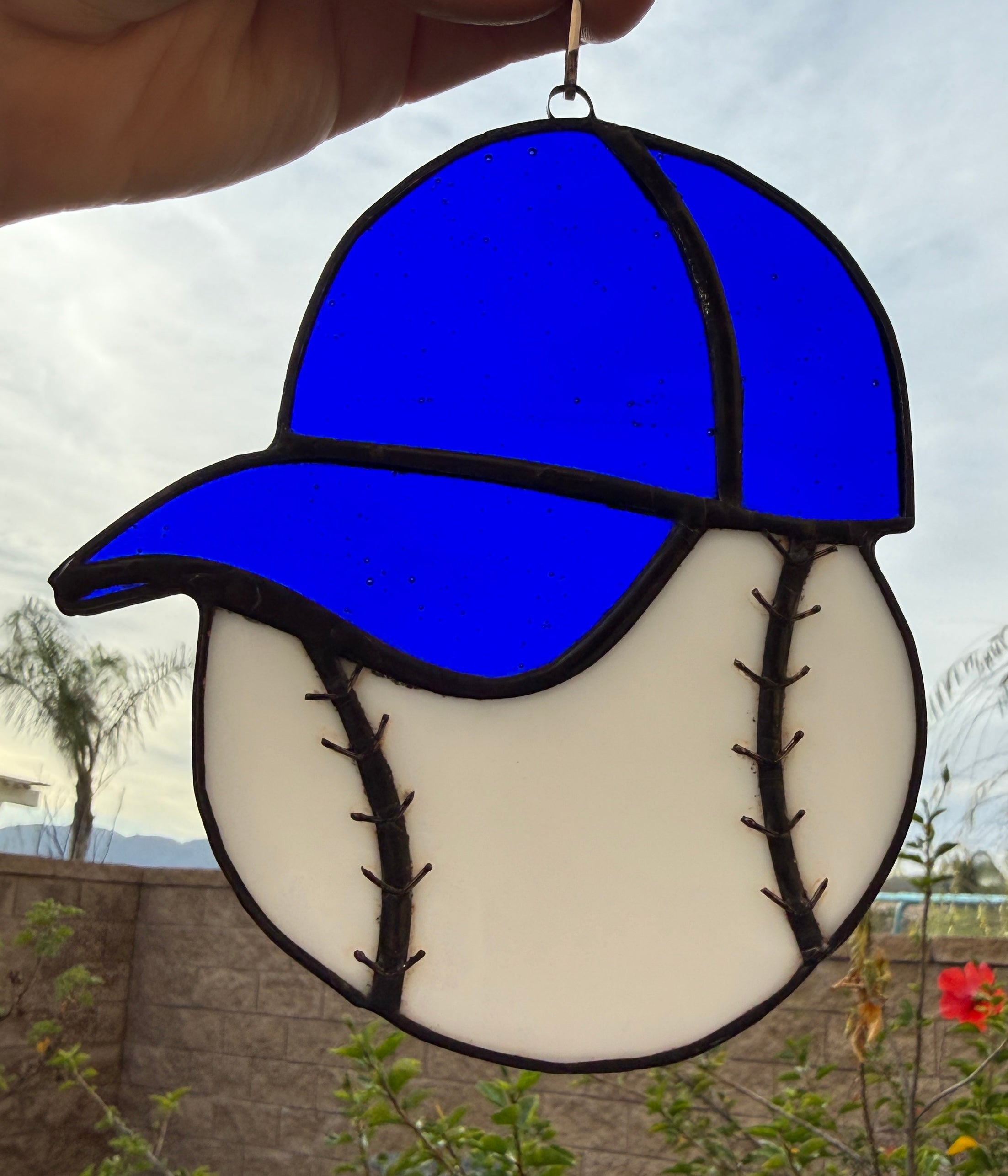 Baseball with blue hat