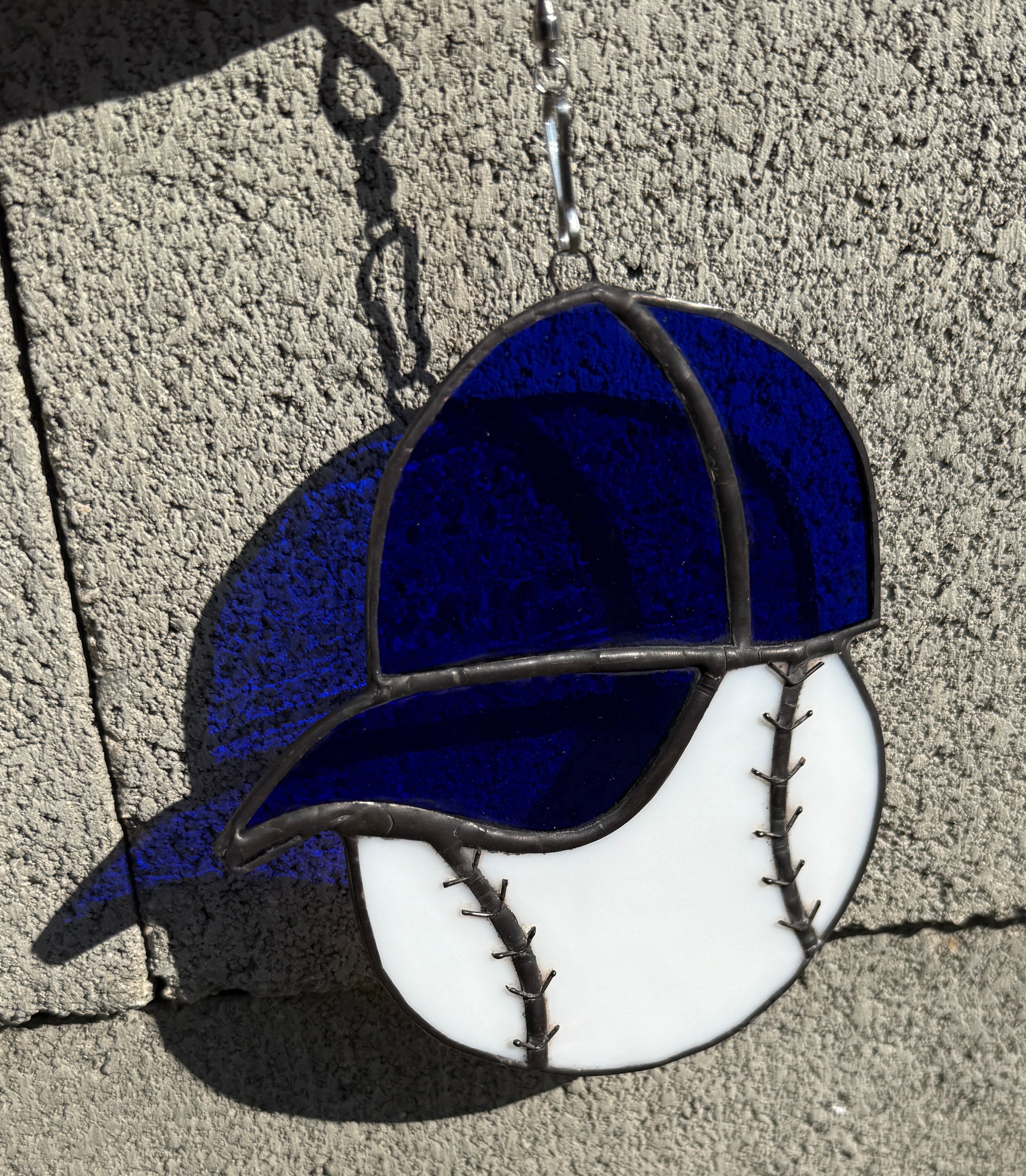 Baseball with blue hat